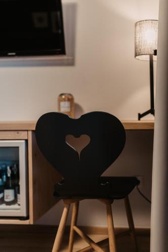 a black chair sitting in front of a desk at Hotel Happy Filzmoos in Filzmoos