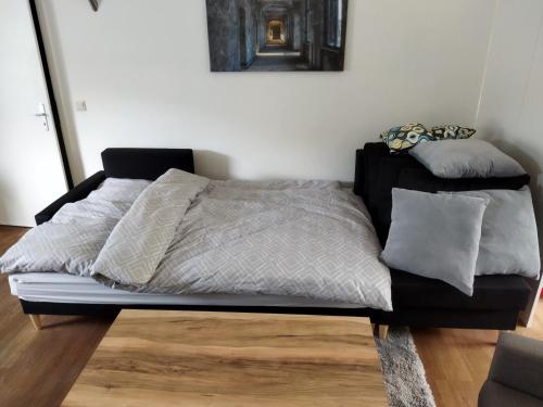 a bed sitting on top of a wooden floor at Salzufler Wohntraum in Bad Salzuflen