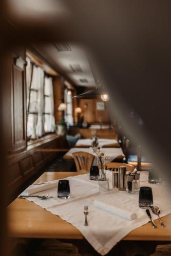 a row of tables in a restaurant with white table cloth at Hotel Happy Filzmoos in Filzmoos