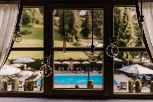 a window with a view of a swimming pool at Hotel Happy Filzmoos in Filzmoos