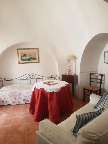 a living room with a table and a couch at Masseria Gianca in Cisternino