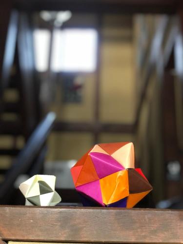 two colorful origami items sitting on a table at The Guest House Japan Hakuba in Hakuba