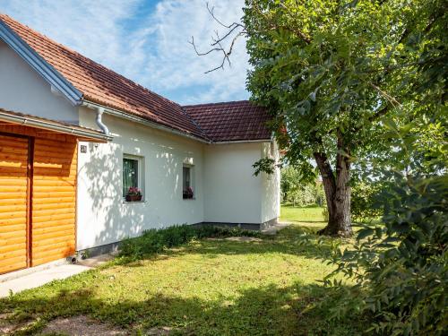 una casa bianca con un albero in cortile di Holiday Home Navis a Karlovac