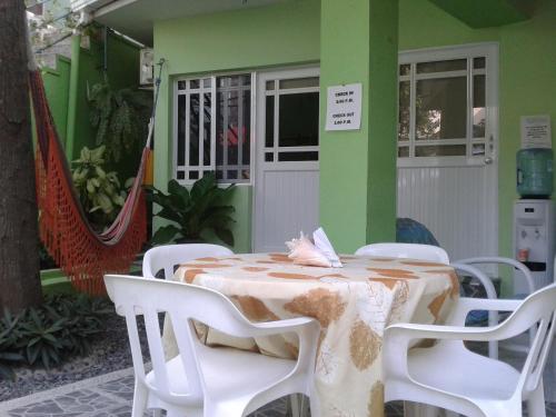 a table and chairs in front of a building at Posada Nativa Bernard Place in San Andrés