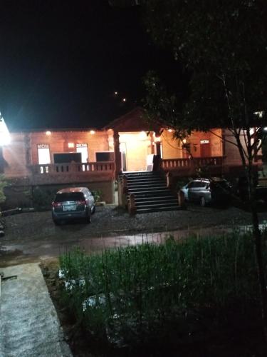 a house at night with cars parked in the driveway at VILLA PRINGGITAN in Karanganyar