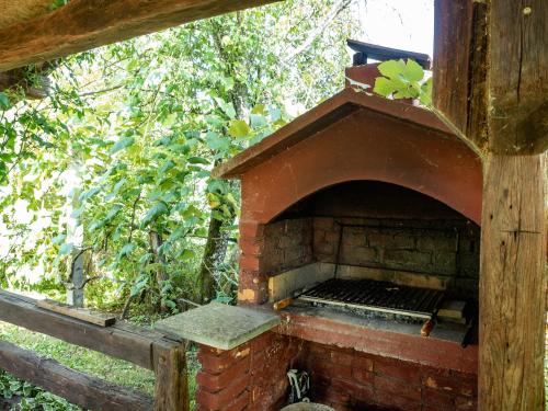 an outdoor brick oven in a wooden structure at Holiday Home Navis in Karlovac