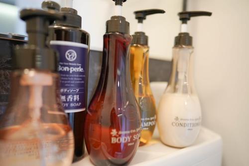 a group of bottles sitting on top of a shelf at Hotel Plaisir Akihabara in Tokyo