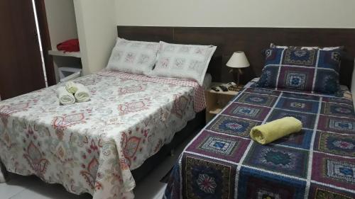 a bedroom with two beds with towels on them at Pousada Pedra do Sossego in Triunfo