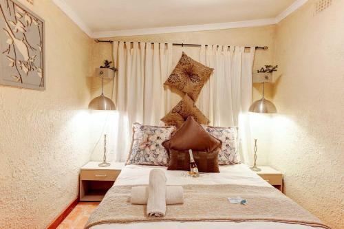 a bedroom with a large bed with two lamps at Strand Guesthouse in Strand