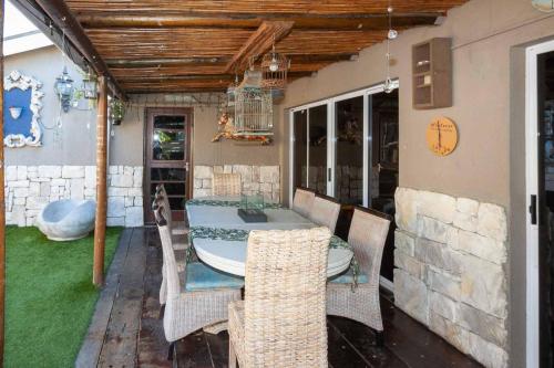 a dining room with a table and some chairs at Strand Guesthouse in Strand