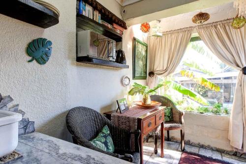 a bathroom with a desk and a sink and a window at Strand Guesthouse in Strand
