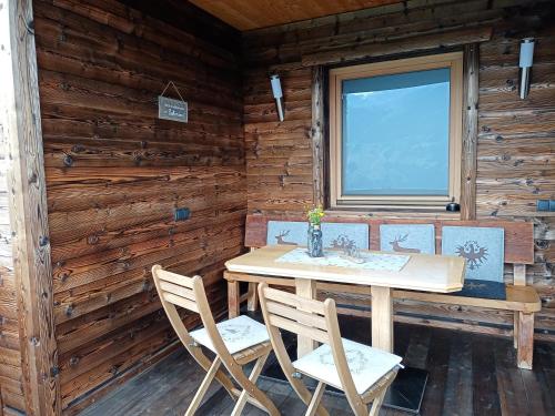 a wooden dining room with a table and chairs at Nesterhof in Aschau