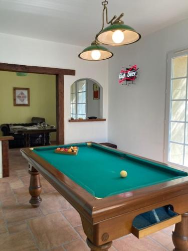 a pool table in a living room with afits at Chambres d'hôtes la Soulenque Luxury B & B in Capestang