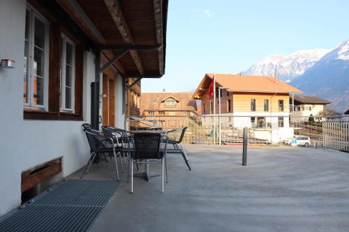 a patio with chairs and a table on a balcony at Royal Swiss Apartments in Ringgenberg