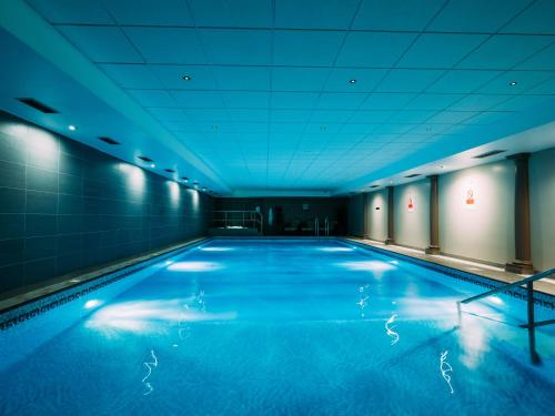 a large room with a large pool of water at Grand Jersey Hotel and Spa in Saint Helier Jersey