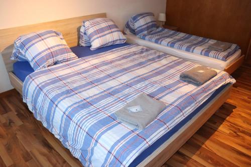 a bed with two pillows on top of it at Royal Swiss Apartments in Ringgenberg