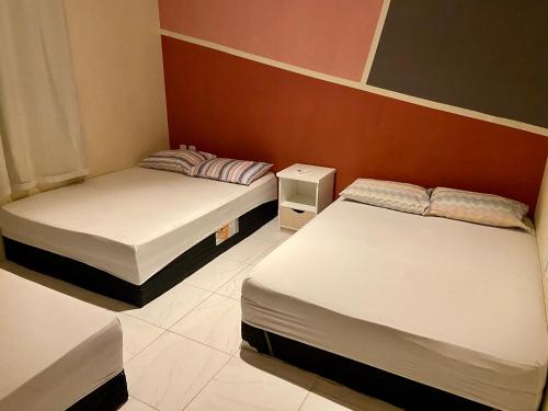 2 camas en una habitación pequeña con 2 camas en Casa Kiwi - Aluguel Temporada, en Porto Seguro