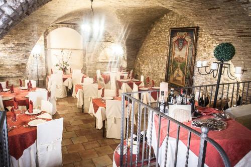 a restaurant with white tables and white chairs at Locanda Dei Baroni in Vasto