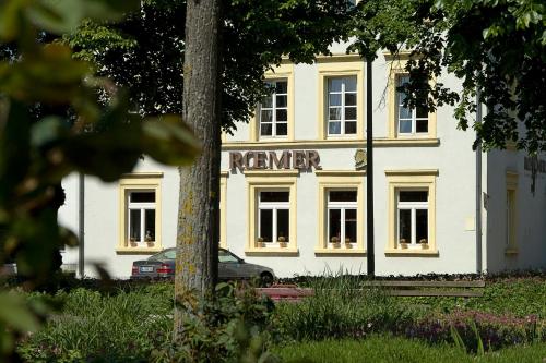 a white building with a sign in front of it at Hotel Restaurant Roemer in Merzig