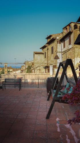 a metal object sitting on a patio with two benches at Casa Anna "a lovely home in Tuscany" in Colle Val D'Elsa