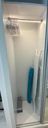 a closet with a refrigerator with aperature at CP Top floor luxury studio in Gibraltar