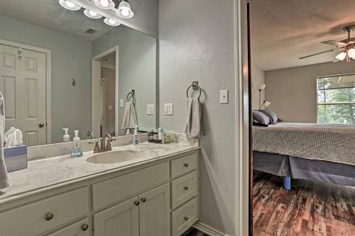 a bathroom with a sink and a large mirror at Relaxing Texas Getaway, 1 Mile to Boat Ramp! in Jefferson