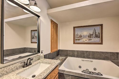 a bathroom with a tub and a large mirror at Deck and Yard Family-Friendly Pinetop Retreat in Indian Pine