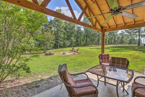 a patio with a table and chairs and a playground at Heavenly Heber Springs Hideaway Fish and Hike! in Heber Springs