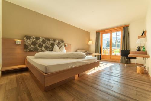 a bedroom with a large bed in a room at Hotel Ucliva in Waltensburg