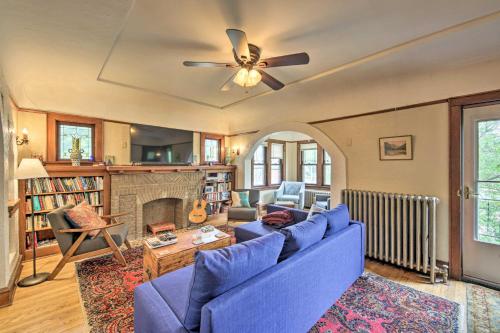 a living room with a blue couch and a fireplace at Chic Milwaukee Apartment in Hip Neighborhood! in Milwaukee