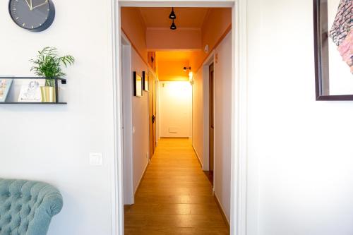 a hallway with white walls and a clock on a wall at Casas da Formosa - Downtown Alegria in Tavira