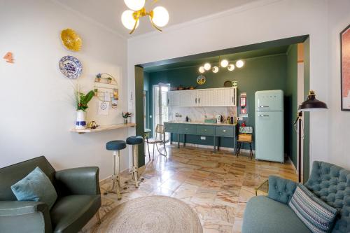 a living room with a refrigerator and a kitchen at Casas da Formosa - Downtown Alegria in Tavira