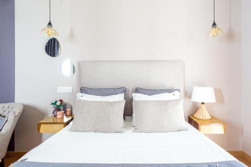a bedroom with a white bed with two pillows at Casas da Formosa - Downtown Alegria in Tavira
