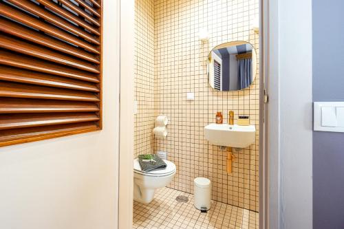 a small bathroom with a toilet and a sink at Casas da Formosa - Downtown Alegria in Tavira
