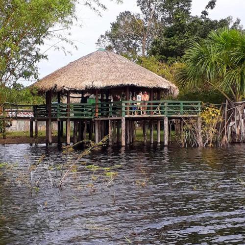 a hut on a pier over a body of water at Amazônia LODGE Exxperience in Manaus