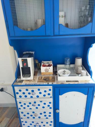 a blue cabinet with some items on top of it at BnB La Casina dei Nonni in Campofilone