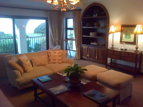 a living room with a couch and a table at Pelagus Guest House in Hermanus