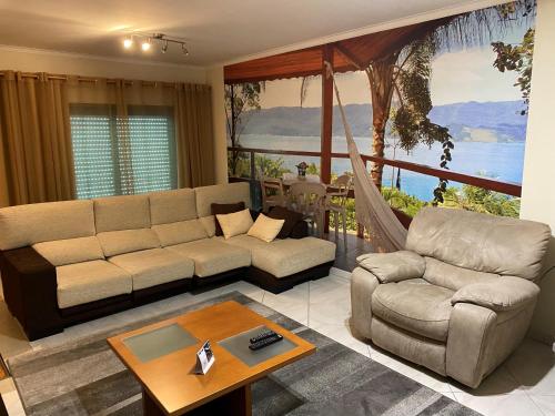 a living room with a couch and a table at Half Way Nazaré - Fátima - NSA-T2 in Marrazes