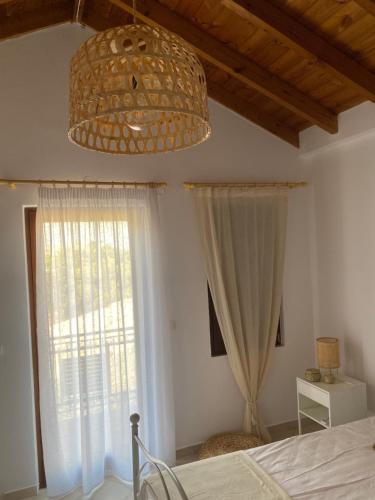 a bedroom with a bed and a large window at Celestia Apartments in Halki