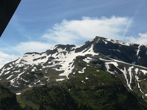 a snow covered mountain with a blue sky and clouds at Avoriaz cocooning in Avoriaz