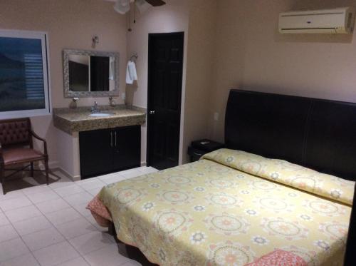 a bedroom with a bed and a sink in it at Suites Atlas - Ocean Front in Bucerías