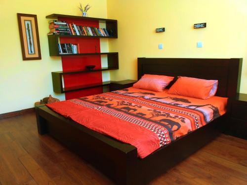 a bedroom with a bed and a book shelf at Стаи за Гости Lavender Lozen in Lozen