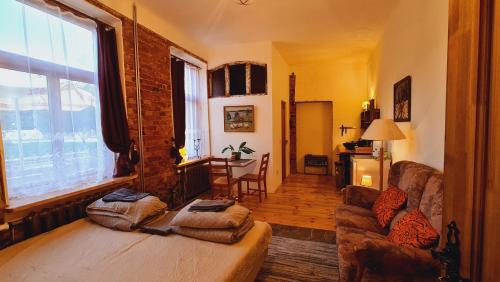 a living room with a couch and a large window at Butterfly House in Pāvilosta