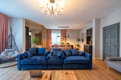 sala de estar con sofá azul y mesa en Craita Merelor The PLACE en Aninoşani