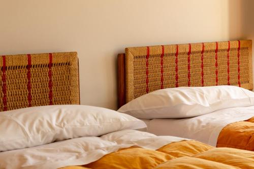 two beds sitting next to each other in a bedroom at Albergo Ristorante Monte Selva in Barisciano