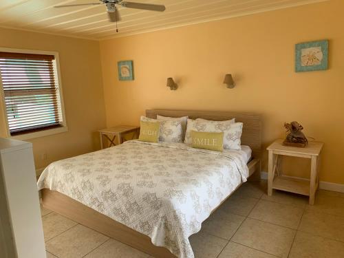 
a bedroom with a large bed and a large window at Snappers Key Largo in Key Largo
