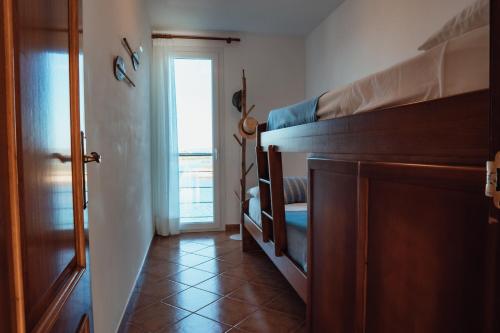 a bedroom with a bunk bed and a hallway with a door at Menurka - Port d'Addaia in Port d'Addaia