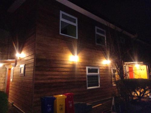 a house with lights on the side of it at night at VALYAK rent apart hotel - Servicios Integrales in Punta Arenas