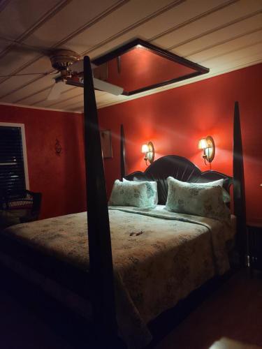 a bedroom with a large bed with red walls at Snappers Key Largo in Key Largo