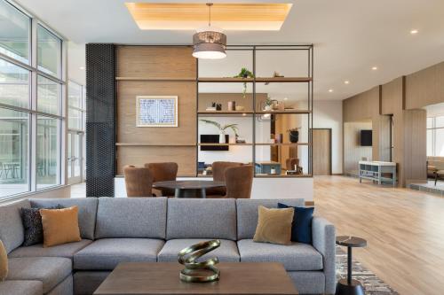 a living room with a couch and a table at EVEN Hotels Rochester - Mayo Clinic Area by IHG in Rochester